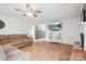 Bright living room features hardwood floors, a ceiling fan, fresh paint, and a decorative fireplace at 6349 Lebanon Rd, Mint Hill, NC 28227