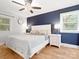 Comfortable bedroom with accent wall featuring bedside tables with lamps and lots of natural light at 6349 Lebanon Rd, Mint Hill, NC 28227