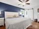 Comfortable bedroom with barn door access and a modern design featuring blue accent wall and neutral finishes at 6349 Lebanon Rd, Mint Hill, NC 28227
