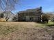 View of the back exterior of the home with a patio and spacious yard at 6827 Neuhoff Ln, Charlotte, NC 28269