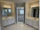 Bathroom featuring double sinks, generous counter space, and entry to the main bedroom and a tub shower at 6827 Neuhoff Ln, Charlotte, NC 28269