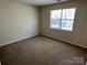 Bedroom featuring carpeted floors and natural light from the window at 6827 Neuhoff Ln, Charlotte, NC 28269