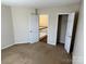 Bedroom featuring neutral walls, carpeted floors, and closet space at 6827 Neuhoff Ln, Charlotte, NC 28269