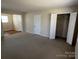 Bedroom with carpet floors, closet and attached room with hardwood flooring at 6827 Neuhoff Ln, Charlotte, NC 28269