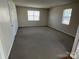 Spacious bedroom with plush carpet, two windows and a closet at 6827 Neuhoff Ln, Charlotte, NC 28269