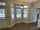 Bright dining area with lots of natural light, chandelier, and space for a table at 6827 Neuhoff Ln, Charlotte, NC 28269