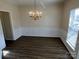 This dining room features hardwood floors, a chandelier, and elegant chair rail molding at 6827 Neuhoff Ln, Charlotte, NC 28269
