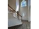 Bright foyer featuring hardwood floors, staircase, and an oval glass front door at 6827 Neuhoff Ln, Charlotte, NC 28269