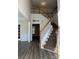 Bright foyer featuring hardwood floors, staircase, and ample natural light at 6827 Neuhoff Ln, Charlotte, NC 28269