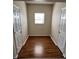Hallway features new, wood-style flooring and a window for natural light at 6827 Neuhoff Ln, Charlotte, NC 28269