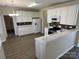 A bright kitchen with white cabinets, stainless steel appliances, and sleek countertops at 6827 Neuhoff Ln, Charlotte, NC 28269