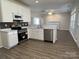 An updated kitchen featuring stainless steel appliances and an open layout to the living area at 6827 Neuhoff Ln, Charlotte, NC 28269