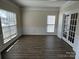 The bright living room features hardwood floors, large windows, and natural light at 6827 Neuhoff Ln, Charlotte, NC 28269