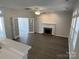 Open-concept living room features a fireplace, hardwood floors, and natural light at 6827 Neuhoff Ln, Charlotte, NC 28269