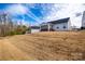 Spacious backyard with a view of the screened porch and detached garage on a sunny day at 715 Bonica Ct, Lancaster, SC 29720