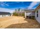 Expansive backyard view with a screened porch and detached garage in a peaceful setting at 715 Bonica Ct, Lancaster, SC 29720