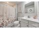 Clean bathroom featuring a shower with a floral curtain, a mirror, and a white vanity at 715 Bonica Ct, Lancaster, SC 29720