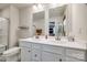 Well-lit bathroom featuring double sinks, white cabinets, a large mirror, and a separate shower area at 715 Bonica Ct, Lancaster, SC 29720