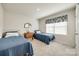 Cozy bedroom with two twin beds, soft carpet, and natural light from the window at 715 Bonica Ct, Lancaster, SC 29720