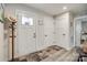Bright foyer showcasing light wood floors, a decorated front door, and convenient coat rack at 715 Bonica Ct, Lancaster, SC 29720