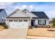 Charming single-Gathering home featuring stone accents, a two-car garage, and a well-manicured lawn at 715 Bonica Ct, Lancaster, SC 29720