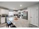 Bright kitchen featuring stainless steel appliances, granite countertops, a kitchen island with seating, and white cabinets at 715 Bonica Ct, Lancaster, SC 29720