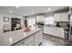 Bright kitchen featuring granite countertops, white cabinets, a stainless steel dishwasher and sink, with an adjoining dining area at 715 Bonica Ct, Lancaster, SC 29720