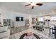 Open-concept living room featuring hardwood floors, a ceiling fan, and modern decor leading into the dining area and kitchen at 715 Bonica Ct, Lancaster, SC 29720