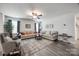 Spacious living room with modern decor, a ceiling fan, comfortable seating, and ample natural light at 715 Bonica Ct, Lancaster, SC 29720