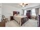 Comfortable main bedroom with a wooden bed frame, dresser, bedside tables, and windows providing ample natural light at 715 Bonica Ct, Lancaster, SC 29720