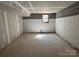 Spacious unfinished basement with painted walls, concrete floors, and natural light at 7939 Holly Hill Rd, Charlotte, NC 28227