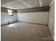 Unfinished basement with painted block walls, concrete floors, and a window at 7939 Holly Hill Rd, Charlotte, NC 28227