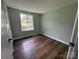 Cozy bedroom with hardwood floors, a window and neutral paint at 7939 Holly Hill Rd, Charlotte, NC 28227