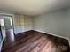 Bedroom featuring hardwood floors and bi-fold closet doors at 7939 Holly Hill Rd, Charlotte, NC 28227