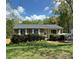 Charming brick and siding home with manicured landscaping and a covered front porch at 7939 Holly Hill Rd, Charlotte, NC 28227