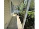 Covered front porch with concrete flooring and view of the surrounding neighborhood at 7939 Holly Hill Rd, Charlotte, NC 28227