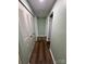 Hallway with closet doors and hardwood floors at 7939 Holly Hill Rd, Charlotte, NC 28227