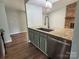 Kitchen island with a stainless steel sink, granite countertop and modern faucet and appliances at 7939 Holly Hill Rd, Charlotte, NC 28227