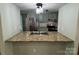 Open kitchen featuring granite countertops, stainless steel appliances, and view to the breakfast bar at 7939 Holly Hill Rd, Charlotte, NC 28227