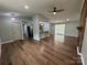 Open-concept living room with hardwood floors, fireplace, and access to a patio at 7939 Holly Hill Rd, Charlotte, NC 28227