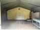 Interior of a metal shed with concrete floor and door at 7939 Holly Hill Rd, Charlotte, NC 28227