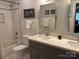 Well-lit bathroom with subway tile shower and double sink vanity at 8111 Sealey Ct, Charlotte, NC 28277