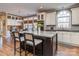 Modern kitchen with granite countertops, custom cabinets, and a center island with bar seating at 8111 Sealey Ct, Charlotte, NC 28277