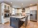 Elegant kitchen with a large island, stainless steel appliances, and white cabinetry at 8111 Sealey Ct, Charlotte, NC 28277
