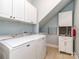 Laundry room with full-size washer and dryer and ample cabinet space at 8111 Sealey Ct, Charlotte, NC 28277