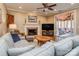 Cozy living room with a fireplace, comfortable seating, and access to screened porch at 8111 Sealey Ct, Charlotte, NC 28277