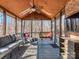 Inviting screened porch with comfortable seating and a ceiling fan at 8111 Sealey Ct, Charlotte, NC 28277