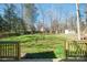 View of a backyard with mature trees and a storage shed at 8733 Canter Post Dr, Charlotte, NC 28216