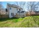 A backyard view of a white two-story house with a wooden deck and fenced yard at 8733 Canter Post Dr, Charlotte, NC 28216