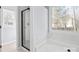 Bathroom with glass shower, garden tub, and window allowing for natural light at 8733 Canter Post Dr, Charlotte, NC 28216